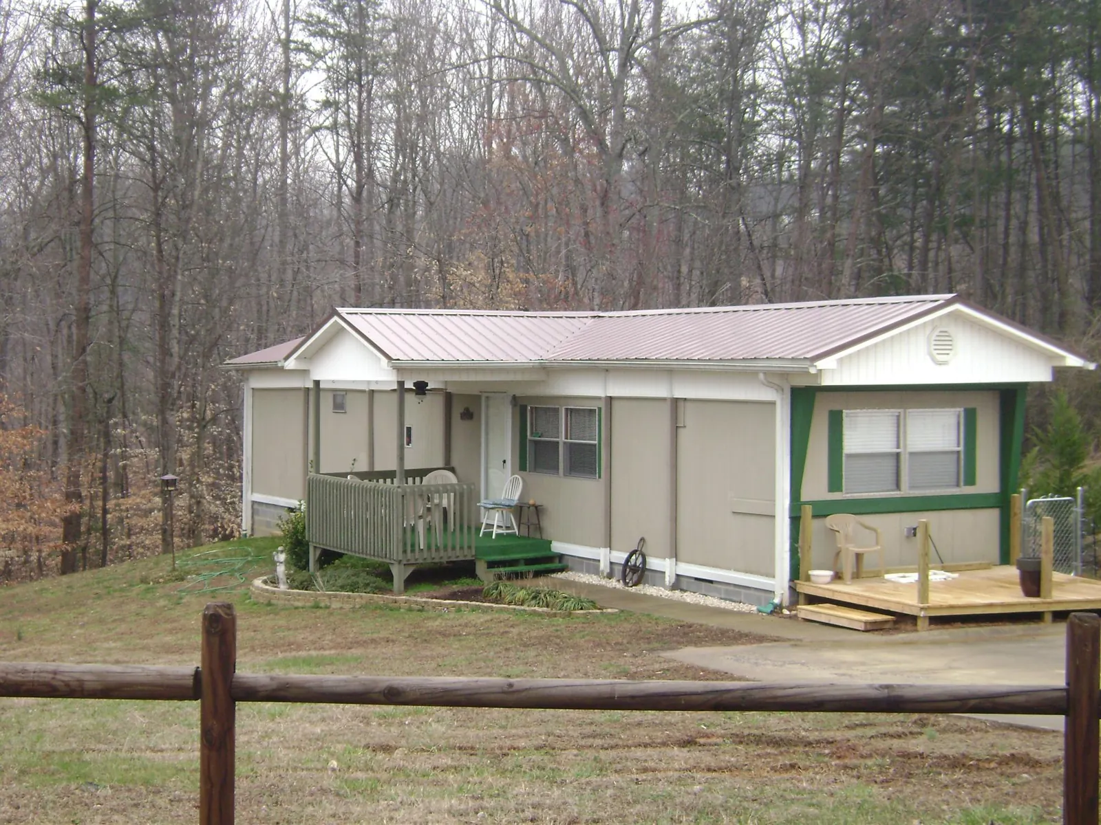Mauve metal roof on a manufactured home with a new front deck in West Union